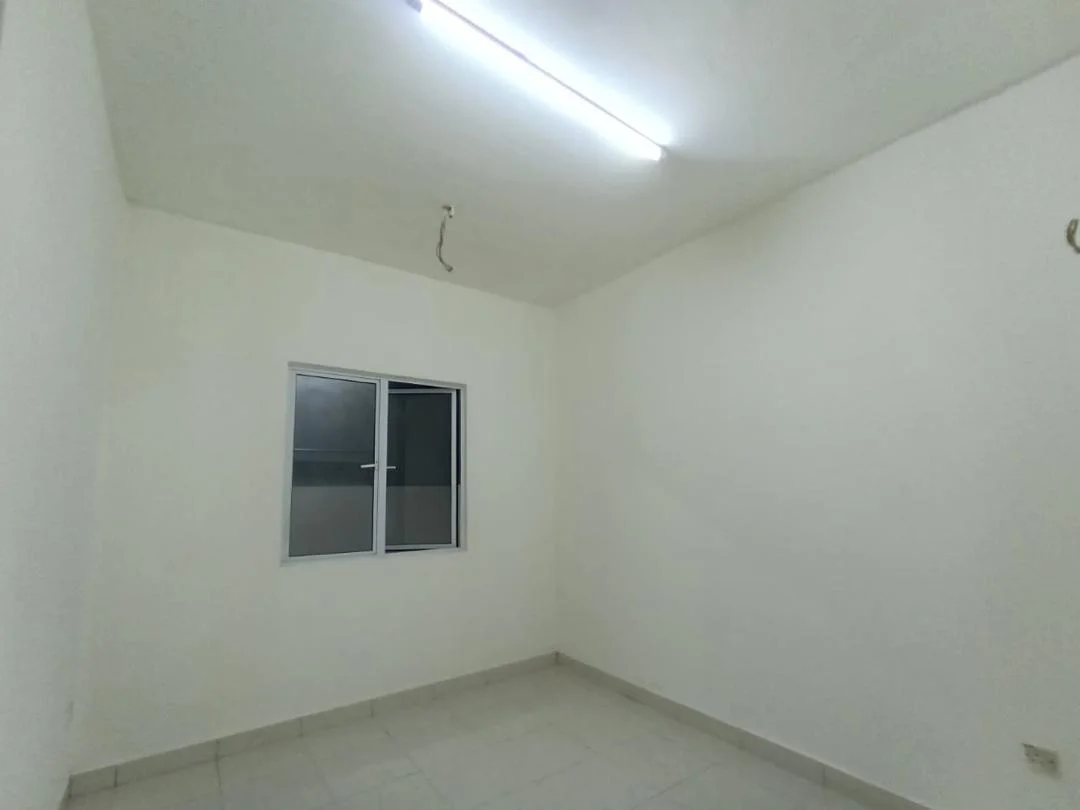 Room features: white painted walls, tile flooring, single window, fluorescent ceiling lights.